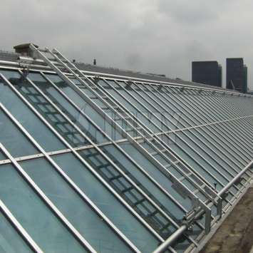 Schuin geplaatste trapladder met lineaire mobiliteit voor glassendak onderhoud. Schuin geplaatste trapladder voor glassendak onderhoud - Building Maintenance Unit